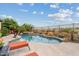 Backyard oasis featuring a sparkling swimming pool, spa, mature trees, and ample patio space at 3373 E Sports Dr, Gilbert, AZ 85298