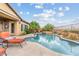 Backyard oasis featuring a sparkling swimming pool, spa, mature trees, and ample patio space at 3373 E Sports Dr, Gilbert, AZ 85298