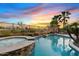 Inviting pool and spa with tropical landscaping create a relaxing backyard oasis at sunset at 3373 E Sports Dr, Gilbert, AZ 85298