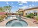 This backyard features a pristine pool and spa, lush landscaping, and an outdoor seating area for relaxation at 3373 E Sports Dr, Gilbert, AZ 85298