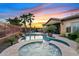 Luxury backyard featuring a pool, spa, lush landscaping, and outdoor amenities under a beautiful evening sky at 3373 E Sports Dr, Gilbert, AZ 85298