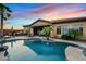 Captivating pool view with spa, swaying palm trees, and an outdoor kitchen for luxurious outdoor living and entertaining at 3373 E Sports Dr, Gilbert, AZ 85298