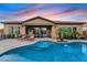 Relaxing backyard with a pristine pool, outdoor seating, and covered patio, perfect for enjoying serene evenings at 3373 E Sports Dr, Gilbert, AZ 85298