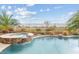 Sparkling swimming pool featuring a stone-accented spa and lush landscaping with views of the community at 3373 E Sports Dr, Gilbert, AZ 85298