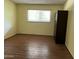 Neutral bedroom featuring laminate wood floors, neutral paint, and a large window at 355 E Thomas Rd # B207, Phoenix, AZ 85012