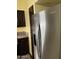 Kitchen featuring a stainless steel Whirlpool refrigerator with a water dispenser and a cabinet at 355 E Thomas Rd # B207, Phoenix, AZ 85012