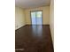 Bright living room features tile flooring, neutral walls, and sliding glass doors to the patio at 355 E Thomas Rd # B207, Phoenix, AZ 85012