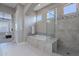 Bright bathroom featuring a soaking tub, glass enclosed shower, and stylish mosaic tile accents at 36169 N Serrano Ave, Queen Creek, AZ 85140