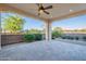 Outdoor patio, beautifully landscaped with decorative stone, plants, and a ceiling fan at 36169 N Serrano Ave, Queen Creek, AZ 85140