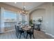 Bright dining room featuring a dining table, chandelier, and large picture window at 36169 N Serrano Ave, Queen Creek, AZ 85140