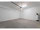 Organized garage with water filtration system and ample space for vehicle storage at 36169 N Serrano Ave, Queen Creek, AZ 85140
