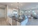 Modern kitchen with granite countertops, stainless steel appliances, and open layout to living space at 36169 N Serrano Ave, Queen Creek, AZ 85140