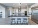 Spacious kitchen featuring a large island, stainless steel appliances, and modern lighting at 36169 N Serrano Ave, Queen Creek, AZ 85140