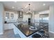 Spacious kitchen with large island, stainless appliances, and contemporary lighting at 36169 N Serrano Ave, Queen Creek, AZ 85140