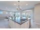 Open-concept kitchen featuring a large island, pendant lighting, and seamless connection to living areas at 36169 N Serrano Ave, Queen Creek, AZ 85140