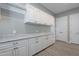 Well-appointed laundry room with ample cabinets, counter space, and modern finishes at 36169 N Serrano Ave, Queen Creek, AZ 85140