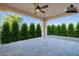 View of the patio with a ceiling fan and view of the yard, lined with decorative bushes at 36169 N Serrano Ave, Queen Creek, AZ 85140