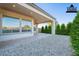 View of the patio, landscaping, windows into the home and ceiling fan at 36169 N Serrano Ave, Queen Creek, AZ 85140