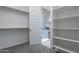 Spacious walk-in closet adjacent to a stylish bathroom, providing convenience and luxury at 36169 N Serrano Ave, Queen Creek, AZ 85140
