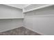 A well-organized walk-in closet with shelves and rods for ample storage space at 36169 N Serrano Ave, Queen Creek, AZ 85140