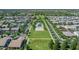 Community aerial featuring tree-lined streets and homes surrounding a central park with amenities at 3859 E Appaloosa Rd, Gilbert, AZ 85296