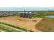 Aerial view showcasing nearby silos, situated near a planned community and a tranquil pond at 3859 E Appaloosa Rd, Gilbert, AZ 85296
