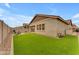 A spacious backyard featuring artificial grass, pavers, and a view of neighboring properties at 3859 E Appaloosa Rd, Gilbert, AZ 85296
