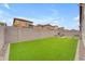 A large backyard with artificial grass, pavers, and a perimeter wall for privacy at 3859 E Appaloosa Rd, Gilbert, AZ 85296
