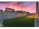 Spacious backyard with artificial turf, a stone patio, and secure block wall fencing, ideal for outdoor activities at 3859 E Appaloosa Rd, Gilbert, AZ 85296