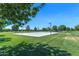 A pristine outdoor basketball court, surrounded by a lush lawn and mature trees at 3859 E Appaloosa Rd, Gilbert, AZ 85296