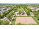 Aerial view featuring a neighborhood park with lush landscaping, picnic areas, playground, and sand volleyball court at 3859 E Appaloosa Rd, Gilbert, AZ 85296