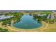 Aerial view of a community pond featuring water fountains and mature trees, a focal point of the neighborhood at 3859 E Appaloosa Rd, Gilbert, AZ 85296