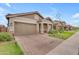 Attractive home exterior with a brick driveway, a well-maintained lawn, and inviting curb appeal at 3859 E Appaloosa Rd, Gilbert, AZ 85296