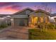 Charming single-Gathering home featuring desert landscaping, stone accents, a two-car garage, and a welcoming covered porch entry at 3859 E Appaloosa Rd, Gilbert, AZ 85296