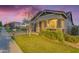 Inviting single-Gathering home featuring lush landscaping, stone accents, and a covered front entry at 3859 E Appaloosa Rd, Gilbert, AZ 85296