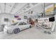 A clean, organized garage with car, tools, storage and lighting at 3859 E Appaloosa Rd, Gilbert, AZ 85296
