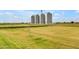 Scenic view of grain silos and sparse trees amid a serene landscape with a distant treeline at 3859 E Appaloosa Rd, Gilbert, AZ 85296
