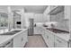 Modern kitchen with stainless appliances and sleek white cabinets, perfect for cooking and entertaining at 3859 E Appaloosa Rd, Gilbert, AZ 85296