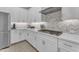 Modern, updated kitchen with bright, white cabinetry, stainless steel appliances, and stylish backsplash at 3859 E Appaloosa Rd, Gilbert, AZ 85296