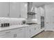Modern kitchen with stainless steel appliances, white cabinetry and a stylish backsplash at 3859 E Appaloosa Rd, Gilbert, AZ 85296