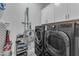 Laundry room featuring black front load washer and dryer with folding station at 3859 E Appaloosa Rd, Gilbert, AZ 85296