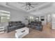 Spacious living room featuring two plush sofas, a modern ceiling fan, and stylish decor at 3859 E Appaloosa Rd, Gilbert, AZ 85296