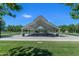 A covered picnic area with picnic tables, seating, and trash receptacles, on a lawn at 3859 E Appaloosa Rd, Gilbert, AZ 85296