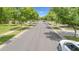 Peaceful street view featuring mature shade trees and a well-maintained road with sidewalks at 3859 E Appaloosa Rd, Gilbert, AZ 85296