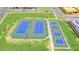 Aerial view of the community tennis courts with vibrant blue and green surfacing, perfect for active residents at 3859 E Appaloosa Rd, Gilbert, AZ 85296