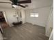 Spacious bedroom with light gray floors, ceiling fan, and a window providing natural light at 4065 E University Dr # 88, Mesa, AZ 85205