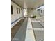 View of covered side patio with walkway and white plastic chair; lattice fencing visible at 4065 E University Dr # 88, Mesa, AZ 85205