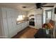 Bright kitchen featuring white cabinetry, essential appliances, and a ceiling fan, providing a functional cooking area at 4065 E University Dr # 88, Mesa, AZ 85205