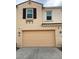 Two car garage and home exterior with classic shutters and desert color palette at 4077 S Sabrina Dr # 94, Chandler, AZ 85248