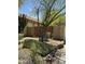 View of the home's backyard with private fence, desert landscaping and red tile roof at 5601 E Monte Cristo Ave, Scottsdale, AZ 85254